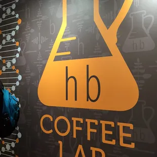 a woman standing in front of a coffee lab sign