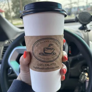 Holding a to geaux cup of coffee from Highland Coffees