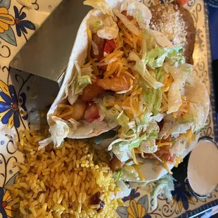 Buffalo Shrimp tacos with rice and beans.