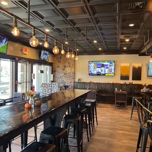 a restaurant with a bar and televisions