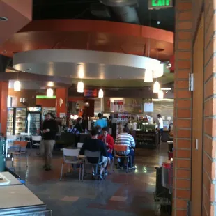 people sitting at tables in a restaurant