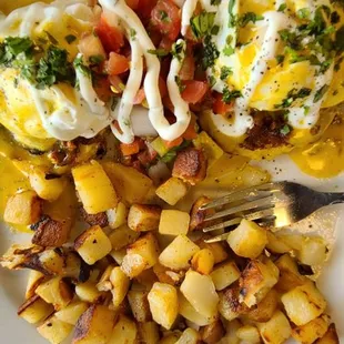 a plate of eggs and potatoes