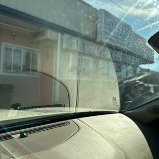 a dog looking out the window of a car