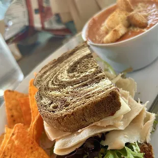 1/2 Turkey Cranberry Sandwich with chips and soup.