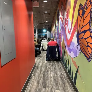 a hallway with a mural of a butterfly