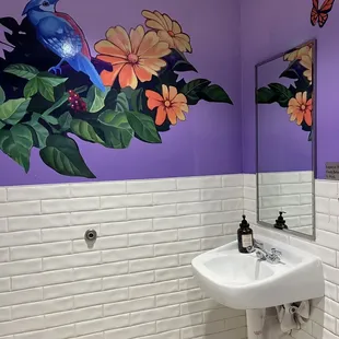a bathroom with a painted wall