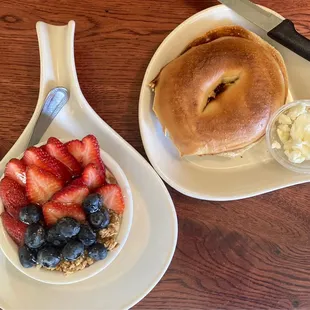 a bagel and a bowl of fruit