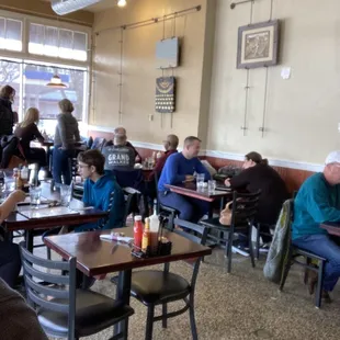 people sitting at tables in a restaurant
