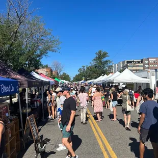 a crowd of people walking down the street