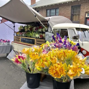 a vw camper van with flowers