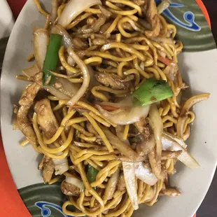 a plate of noodles and meat