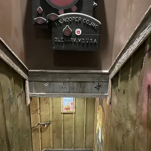 a narrow hallway with graffiti on the walls