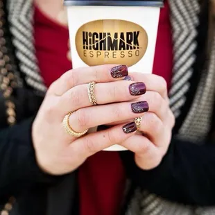 a woman holding a cup of coffee