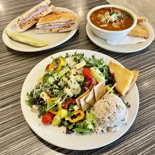 Italian chop salad (front), muffuletta (top left), bowl of Italian bean soup (top right)