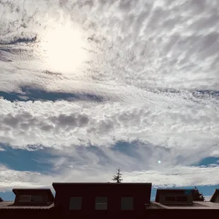 Outside patio area, building, and a great sky.