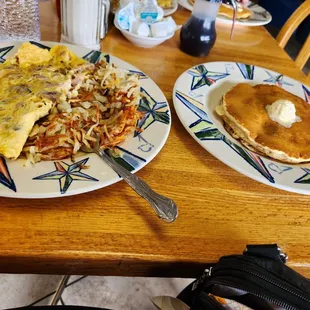 Meat lovers omelet with swiss and pancakes.