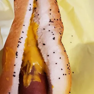 a hot dog with cheese and mustard