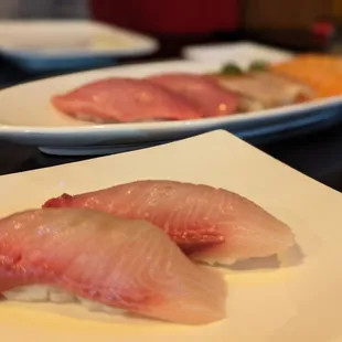 two plates of sushi on a table