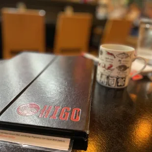 a menu and a coffee cup