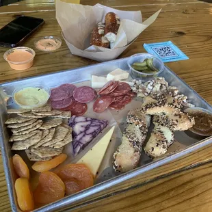 Charcuterie and pretzels behind them.