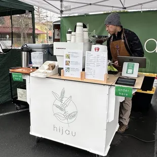 a man standing behind a table with food on it