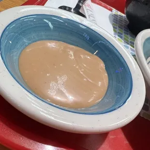 two bowls of food on a red tray