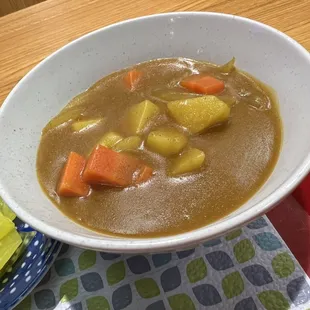 a bowl of stew with carrots and potatoes
