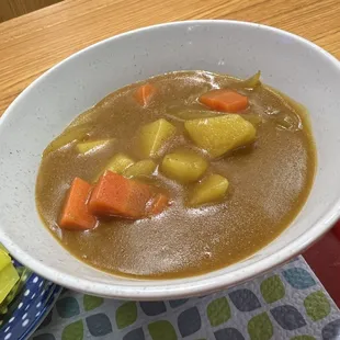 a bowl of stew with carrots and potatoes