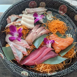 Sashimi Combination: From top-left clockwise: Octopus, Escolar, Albacore, Salmon, Tuna, Red Snapper, Yellowtail at center.