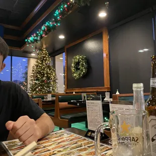 a man sitting at a table with a glass of beer