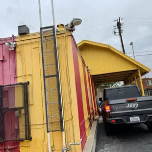 a truck parked in front of a colorful building