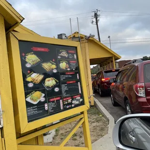 a menu on the side of a building