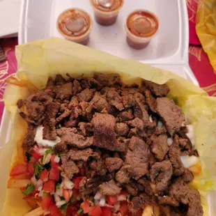 Carne asada fries with 3 small hot sauces. 2 were 3/4 full. No more large hot sauce.