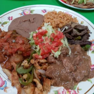 Loco plate chicken and beef fajitas...chicharon guiso and rice and beans and a huge flour tortilla