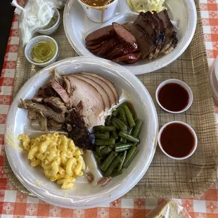 Turkey, pulled pork, beans, Mac n Cheese, brisket, sausage, beans and potato salad. Bread, pickles, onions and sauce on the side.
