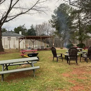 a picnic area with picnic tables and chairs