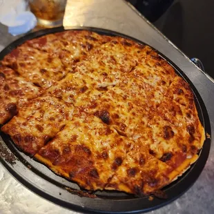 a cheese pizza on a pan