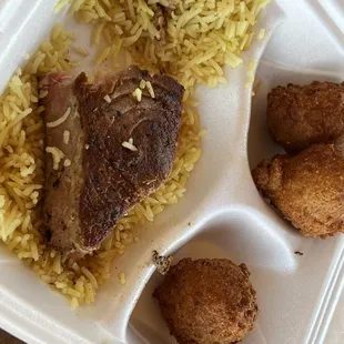 Grilled tuna steak with blackened cabin seasoning (I think?), with hush puppies and seasoned rice.