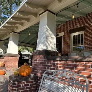 the front porch of a brick house