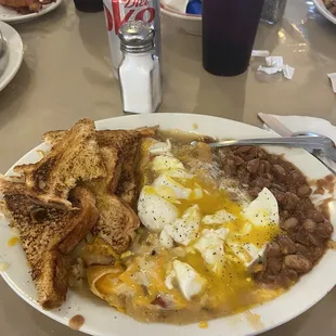 Cheese enchiladas with poached eggs, beans, toast, hash browns