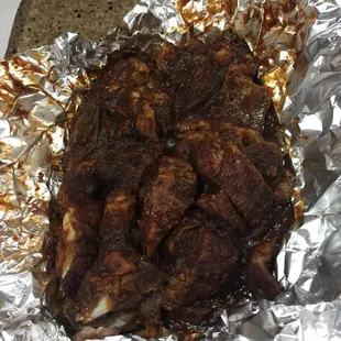 a piece of meat wrapped in tin foil