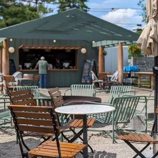 Looking from one of the umbrella covered tables towards where you place and pick up your order.