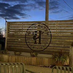 a wooden fence with a clock on it