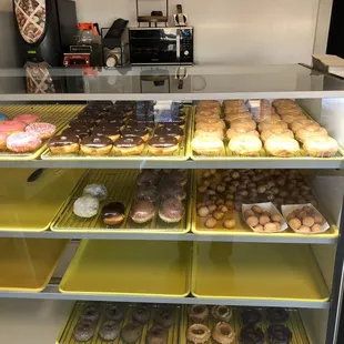 Display case with FRESHLY made donuts by hand; not the ones store bought and frozen.