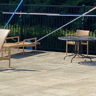 There were pool cleaning tools leaning against the fence which could fall over on a child. They should be stored.