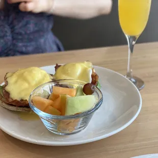 a plate of food and a glass of orange juice