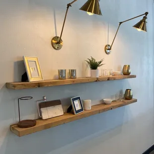 a wall with shelves and lamps