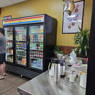 a woman standing in front of a refridgerator