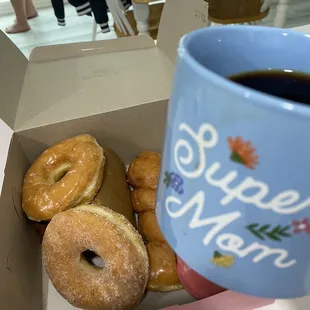 a cup of coffee and a box of doughnuts