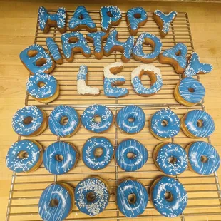 blue frosted donuts on a cooling rack